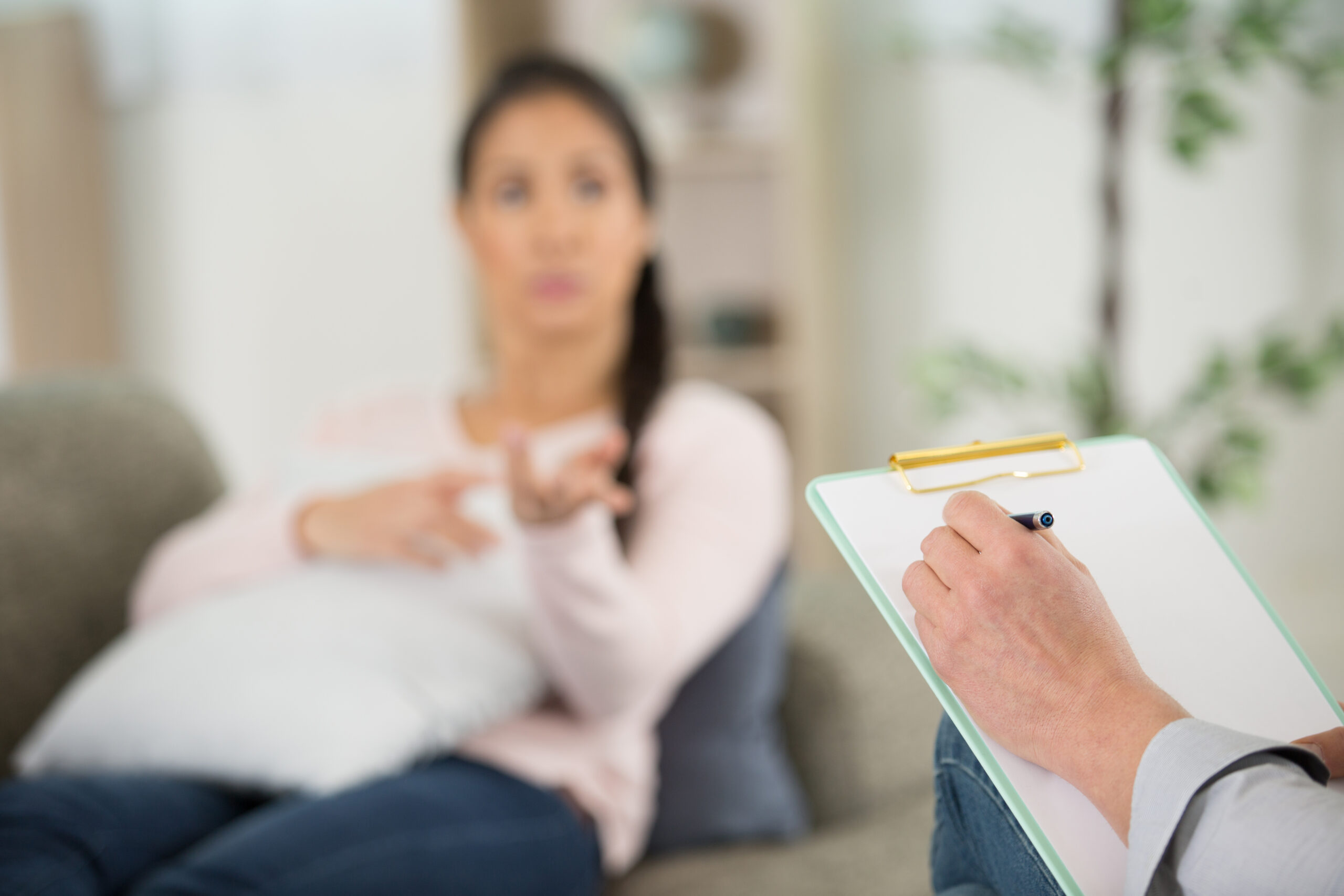 close view of a psychologists clipboard during therapy session